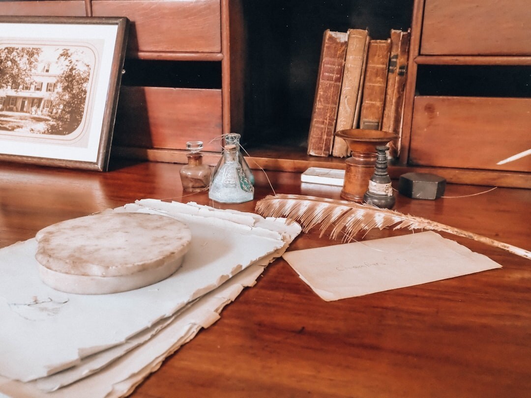Vintage wooden writing desk with a pen and notebook